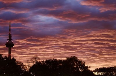 Silhouette tower against sky during sunset