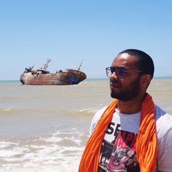 Man in sea against clear sky