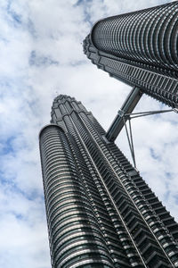 Low angle view of modern building against cloudy sky