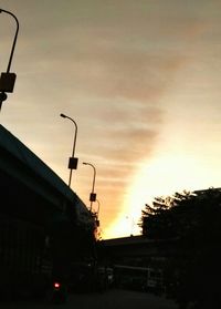 Low angle view of illuminated street light against sky