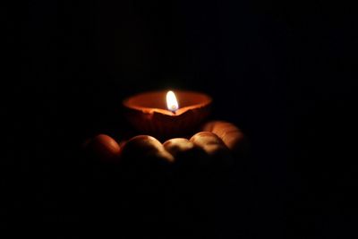 Close-up of human hand against black background