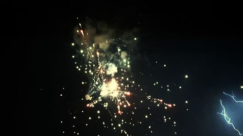 Low angle view of firework display at night