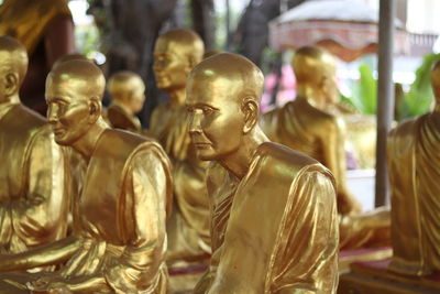 Some golden color monk statue with blur background