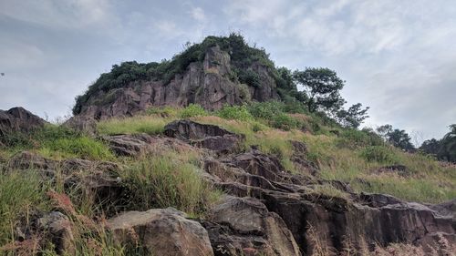 Low angle view of rock formations against sky