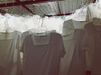 Close-up of white color dresses hanging in coat hangers