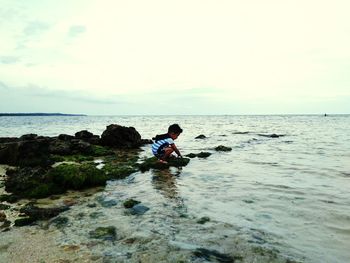 Boy playing in sea at beach