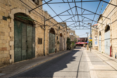 Street amidst buildings against clear sky