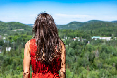 Rear view of woman looking at camera