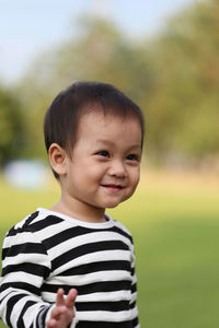 Close-up of cute boy standing at park