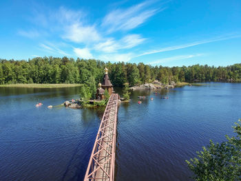 Scenic view of lake against blue sky and a church on the island with the bridge 