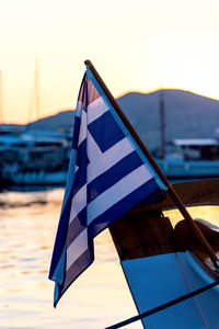 Close-up of flag against sky during sunset