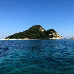 Scenic view of sea against clear blue sky