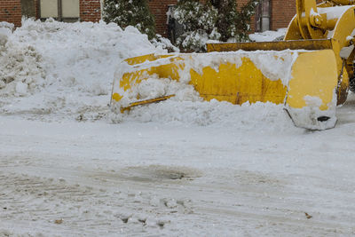 Snow covered road in city