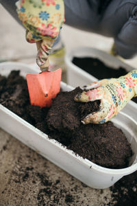 Girl working in the garden with spatula.