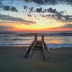 Scenic view of beach against sky during sunset