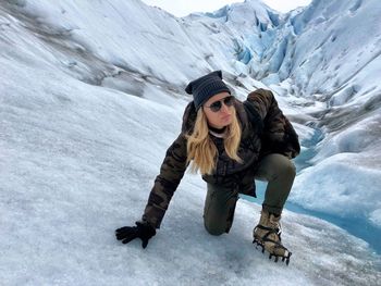 Woman climbing on glacier