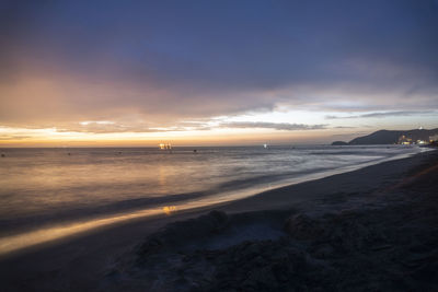 Scenic view of beach against sky during sunset