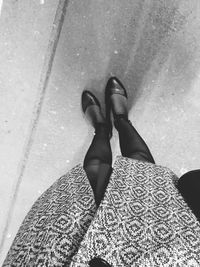 Low section of woman standing on street
