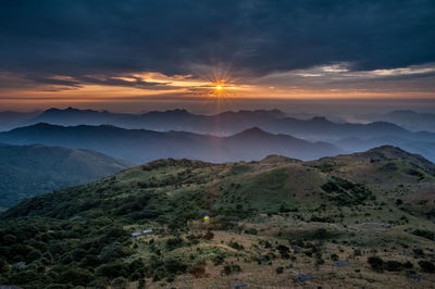 Scenic view of mountains against sky during sunset