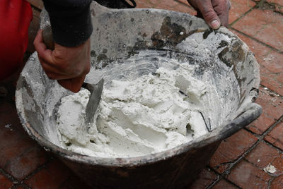 Hands of man working in masonry, unrecognisable