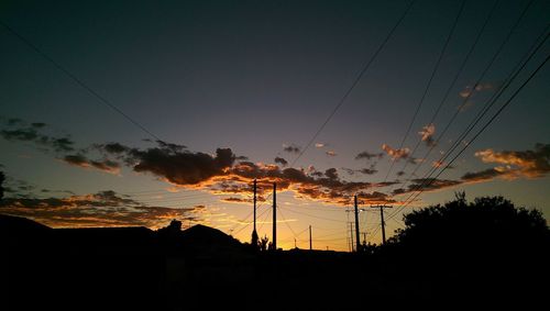 Low angle view of silhouette trees against sky at sunset