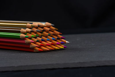 Close-up of multi colored pencils on table