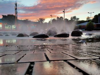 Surface level of water fountain against sky during sunset