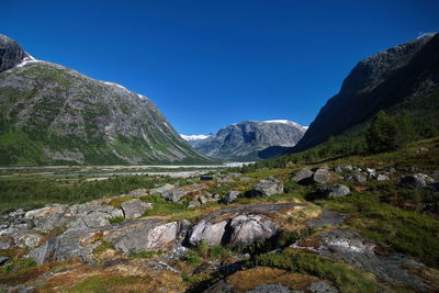 Scenic view of mountains against clear blue sky