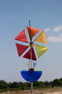 Close-up of red flag against blue sky