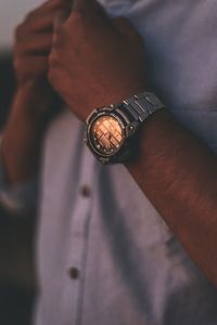 Close-up of hand holding clock