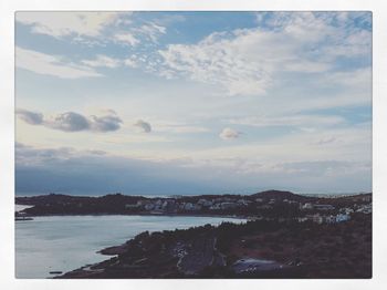 Scenic view of sea and cityscape against sky