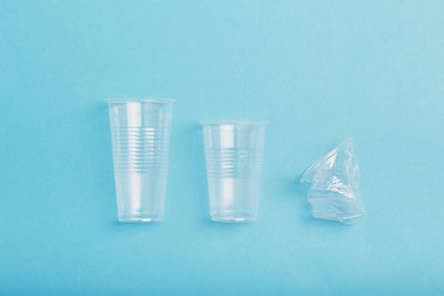 Plastic glasses on blue background