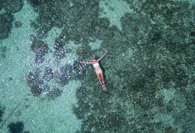 High angle view of woman swimming in sea