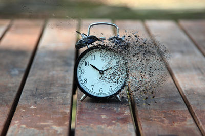 Digital composite image of alarm clock on table