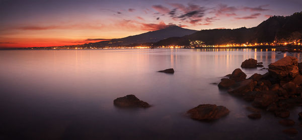 Scenic view of lake against sky during sunset