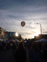 People in town square against sky