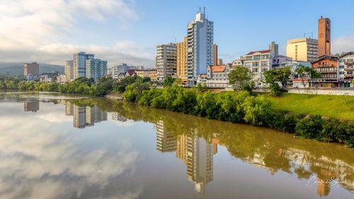 Reflection of buildings in lake against sky