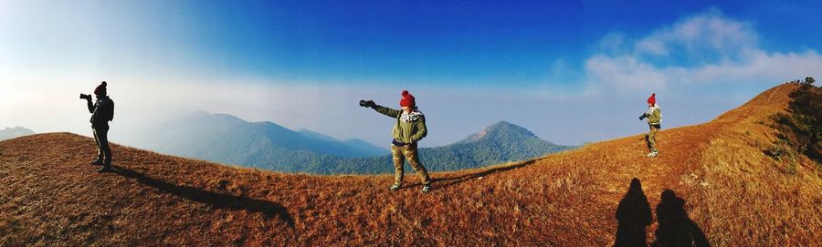 Panoramic view of mountain range against blue sky