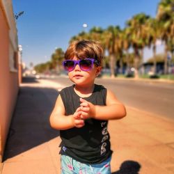 Portrait of boy wearing sunglasses standing outdoors