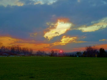 Scenic view of field against sky during sunset