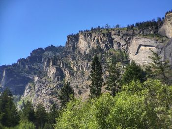 Scenic view of mountains against clear blue sky