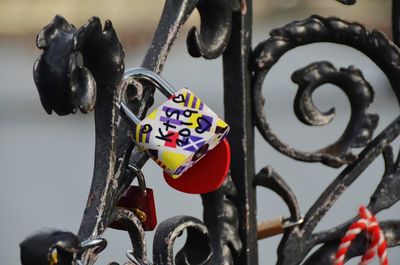 Close-up of padlocks hanging on fence