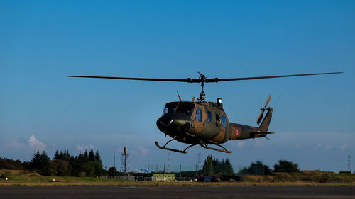 Military helicopter landing against sky