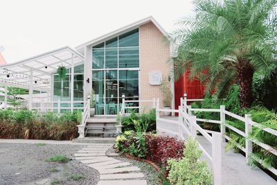 Exterior of building by plants against sky