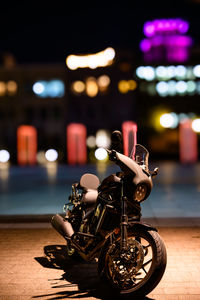 Close-up of motorcycle on street at night