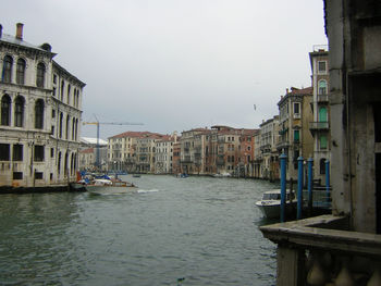 Boats in city against clear sky