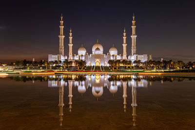 Reflection of illuminated buildings in lake at night