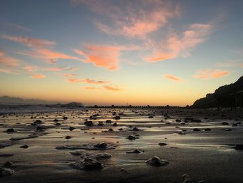 Scenic view of beach against sky during sunset