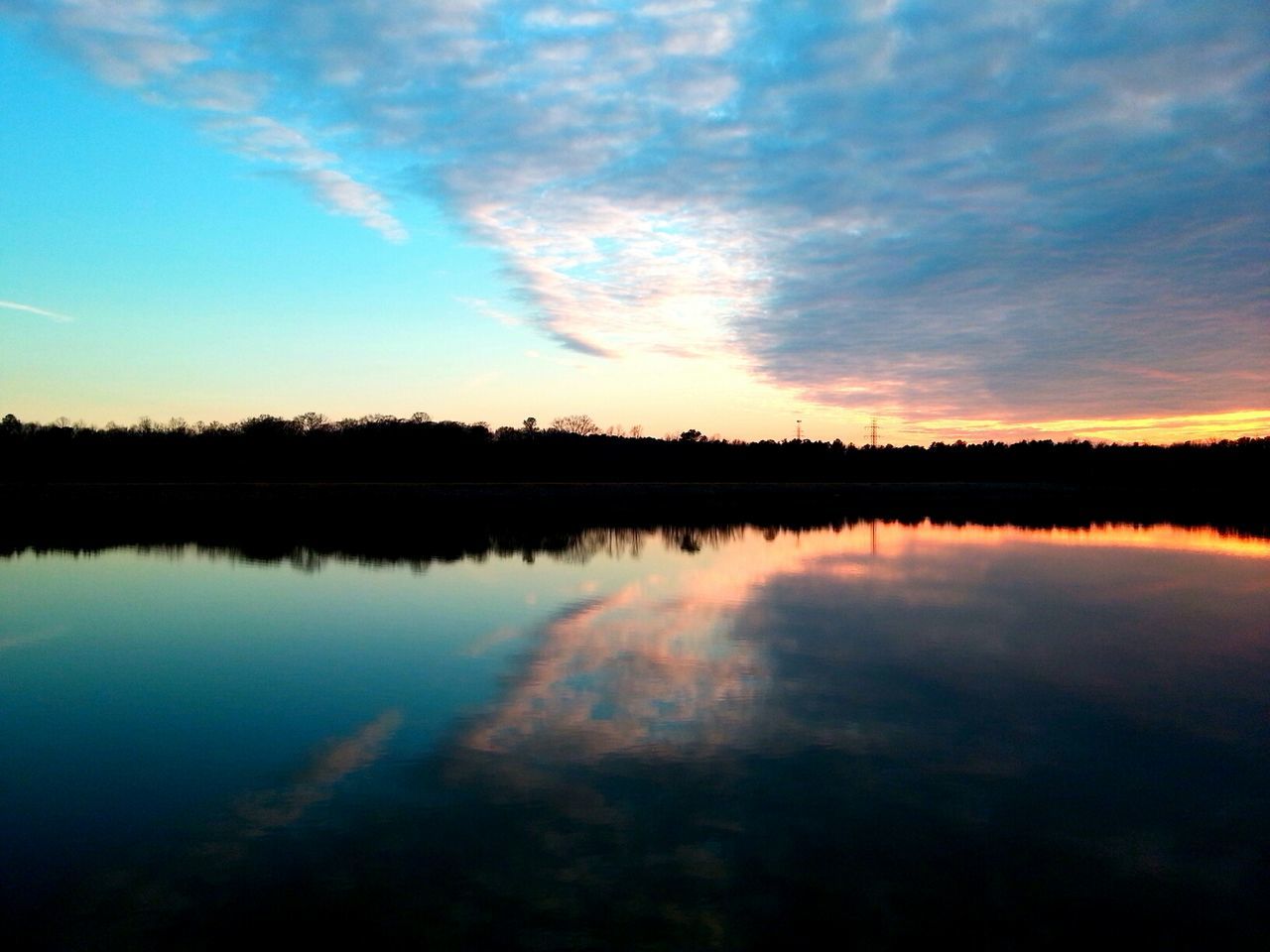 reflection, tranquil scene, water, tranquility, lake, scenics, sky, beauty in nature, sunset, standing water, silhouette, nature, idyllic, waterfront, calm, blue, cloud - sky, cloud, symmetry, majestic