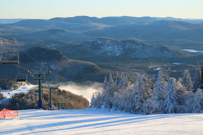 Scenic view of snow covered mountains against sky